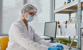 Researcher using laptop at work in the lab {{brizy_dc_image_alt entityId=